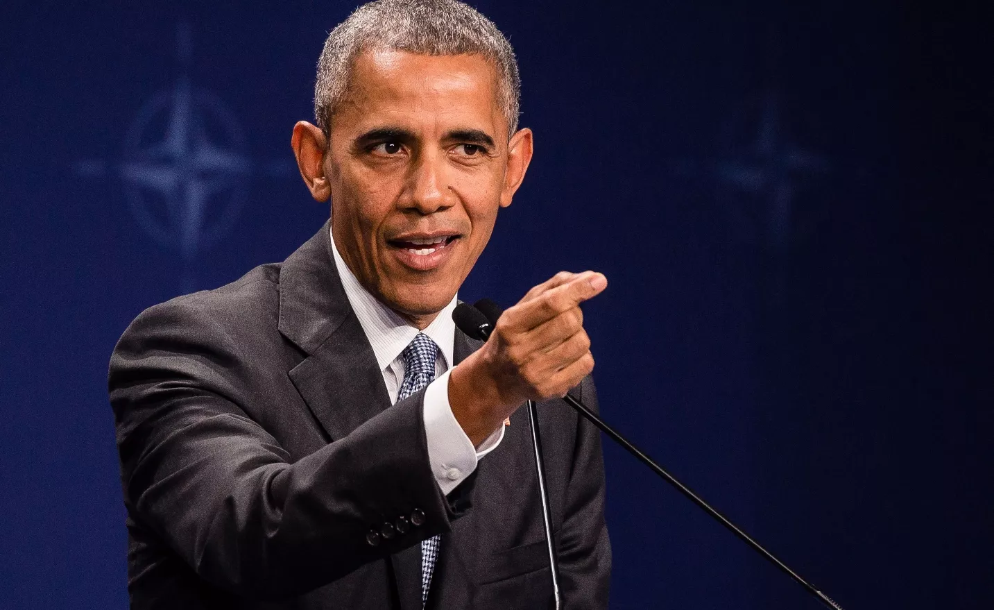 Portrait of Barack Obama beside analytical score graphics representing an unverified IQ estimate