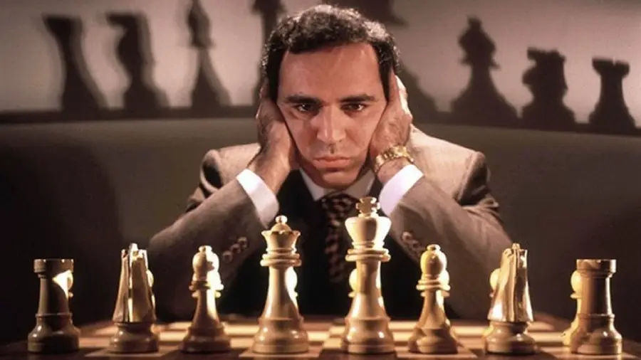 Garry Kasparov portrait beside reported IQ scores 135 and 123 on separate tests