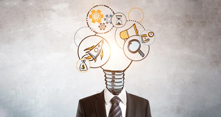 A man in a dark suit and striped tie stands against a gray concrete wall with a drawn light bulb in place of his head, surrounded by circled icons including a rocket, gears, a megaphone, a magnifying glass, an hourglass and a money bag.